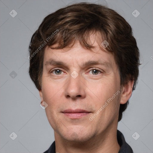 Joyful white adult male with short  brown hair and grey eyes