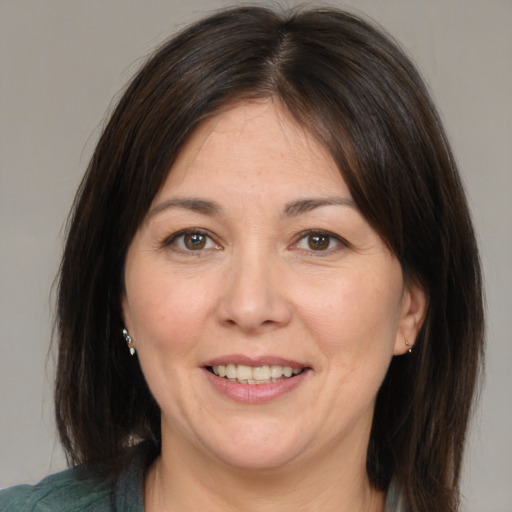 Joyful white adult female with medium  brown hair and brown eyes