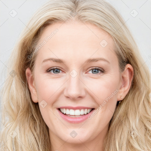 Joyful white young-adult female with long  brown hair and blue eyes