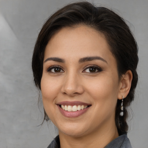 Joyful white young-adult female with medium  brown hair and brown eyes