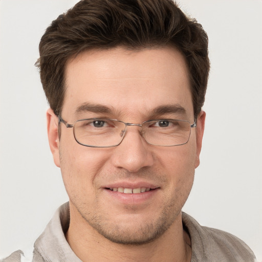 Joyful white adult male with short  brown hair and grey eyes