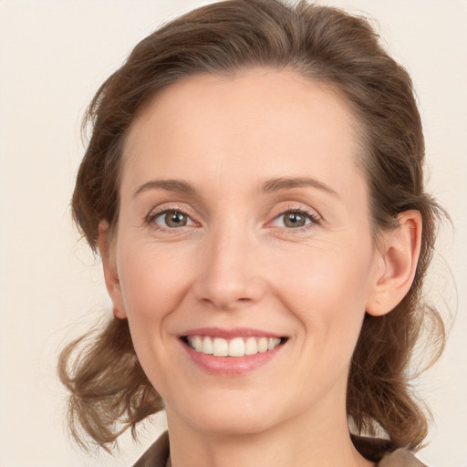 Joyful white young-adult female with medium  brown hair and grey eyes