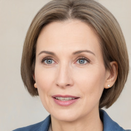 Joyful white adult female with medium  brown hair and grey eyes