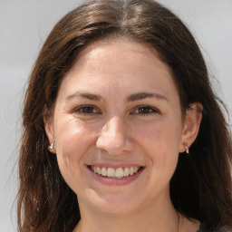 Joyful white adult female with long  brown hair and brown eyes