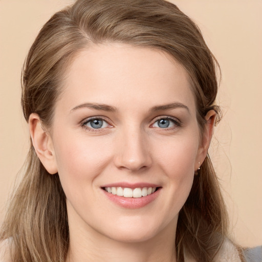 Joyful white young-adult female with long  brown hair and grey eyes