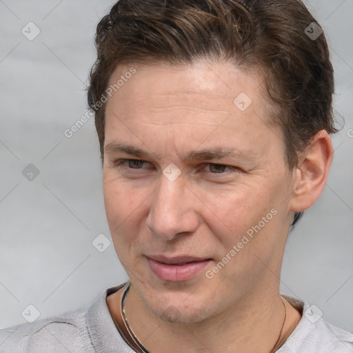 Joyful white adult male with short  brown hair and grey eyes