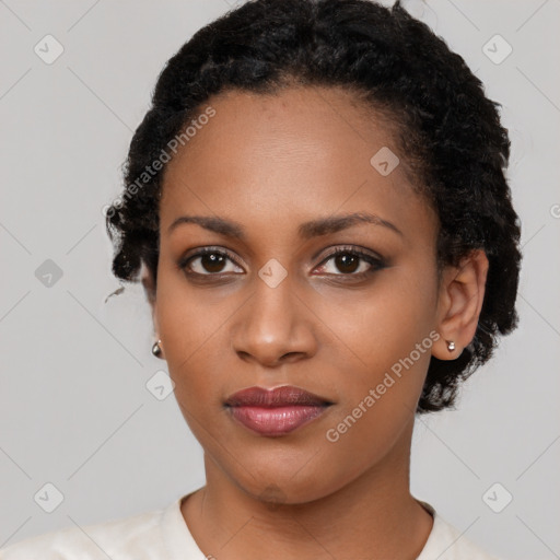 Joyful black young-adult female with short  black hair and brown eyes