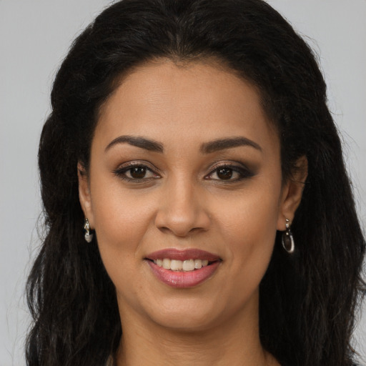 Joyful latino young-adult female with long  brown hair and brown eyes