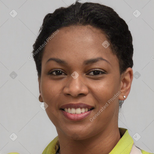 Joyful black young-adult female with short  black hair and brown eyes