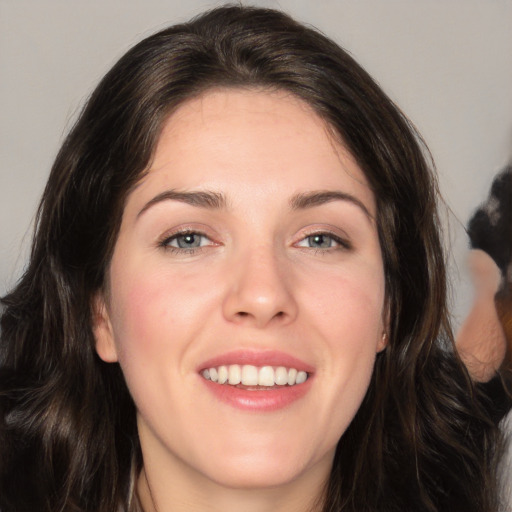 Joyful white young-adult female with long  brown hair and green eyes