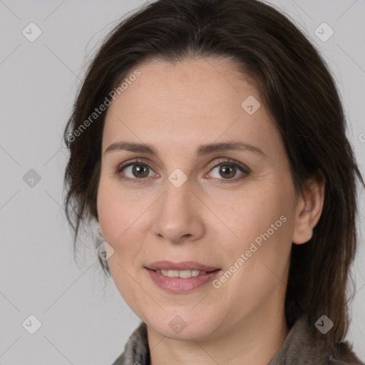 Joyful white adult female with medium  brown hair and brown eyes