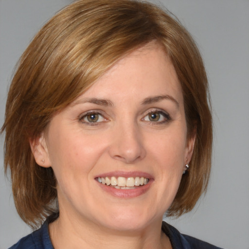 Joyful white adult female with medium  brown hair and brown eyes