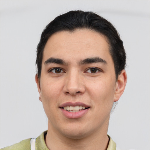 Joyful latino young-adult male with short  black hair and brown eyes