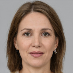 Joyful white adult female with medium  brown hair and grey eyes