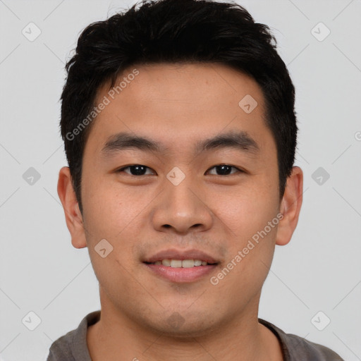 Joyful asian young-adult male with short  brown hair and brown eyes