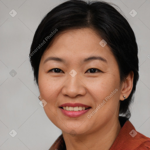 Joyful asian adult female with medium  brown hair and brown eyes