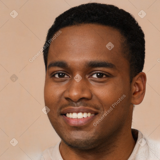 Joyful black young-adult male with short  black hair and brown eyes