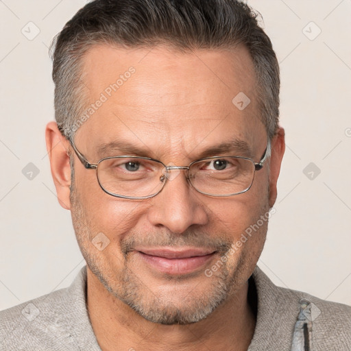 Joyful white middle-aged male with short  brown hair and brown eyes