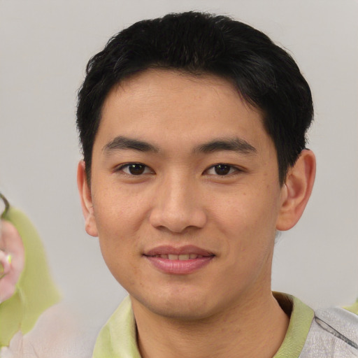 Joyful asian young-adult male with short  black hair and brown eyes