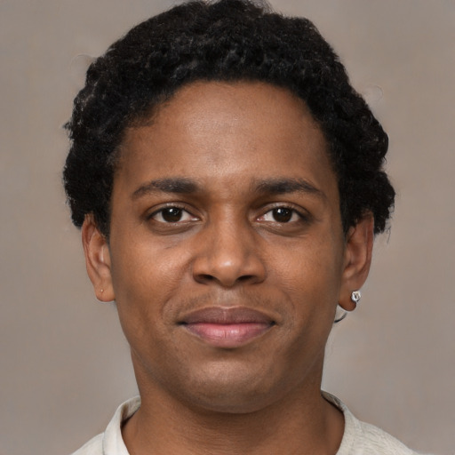 Joyful latino young-adult male with short  brown hair and brown eyes