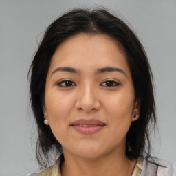 Joyful latino young-adult female with medium  brown hair and brown eyes