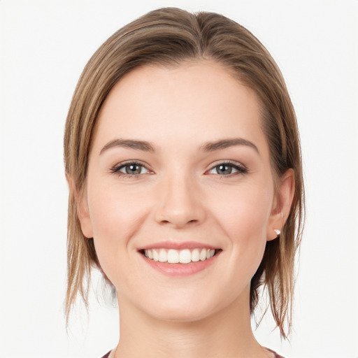 Joyful white young-adult female with long  brown hair and grey eyes