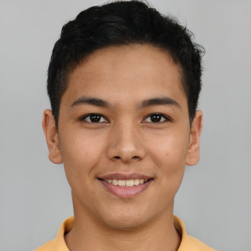 Joyful latino young-adult male with short  brown hair and brown eyes