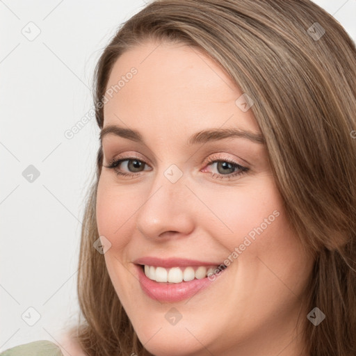 Joyful white young-adult female with long  brown hair and green eyes