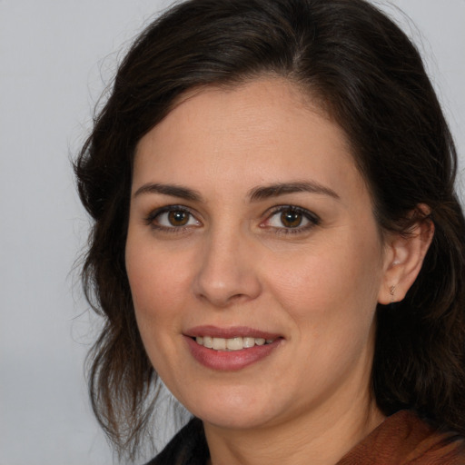 Joyful white young-adult female with medium  brown hair and brown eyes