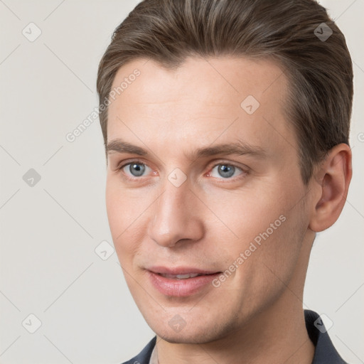 Joyful white young-adult male with short  brown hair and grey eyes