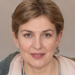 Joyful white adult female with medium  brown hair and grey eyes