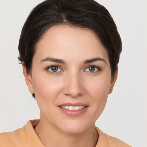 Joyful white young-adult female with short  brown hair and brown eyes