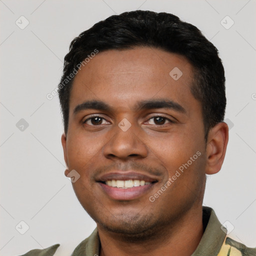 Joyful black young-adult male with short  black hair and brown eyes