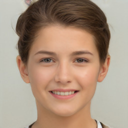 Joyful white child female with short  brown hair and brown eyes