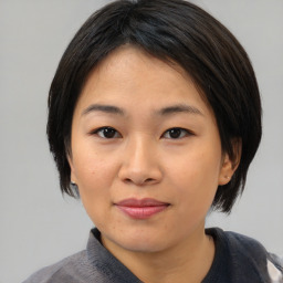 Joyful asian young-adult female with medium  black hair and brown eyes