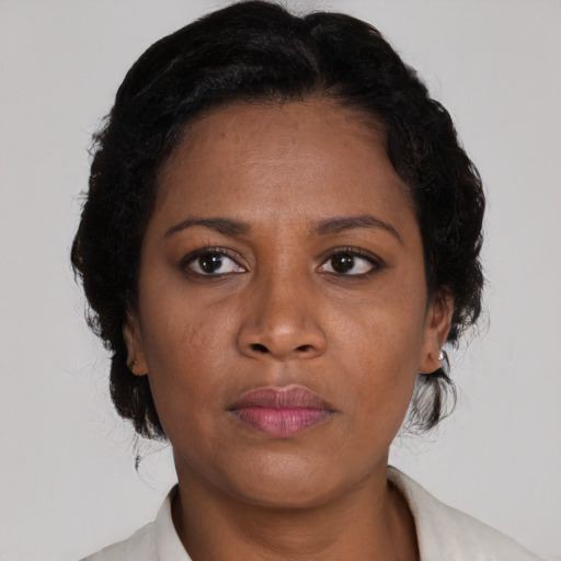 Neutral black adult female with medium  brown hair and brown eyes