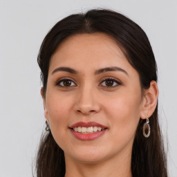 Joyful white young-adult female with long  brown hair and brown eyes