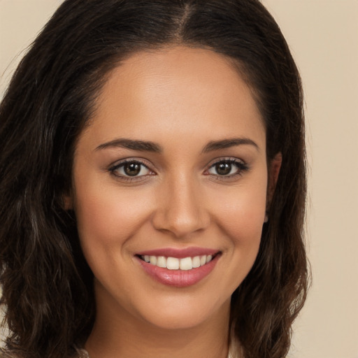 Joyful white young-adult female with long  brown hair and brown eyes