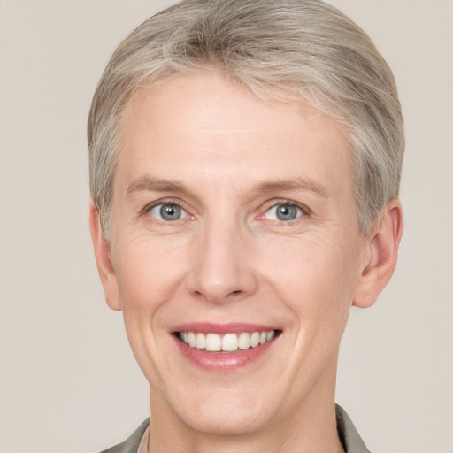 Joyful white adult female with short  brown hair and grey eyes