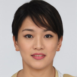 Joyful asian young-adult female with short  brown hair and brown eyes