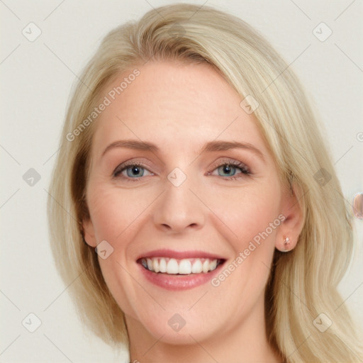 Joyful white young-adult female with medium  brown hair and blue eyes