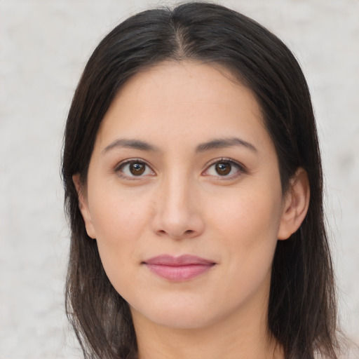 Joyful asian young-adult female with long  brown hair and brown eyes