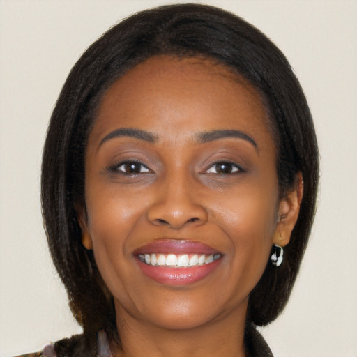 Joyful black young-adult female with medium  brown hair and brown eyes