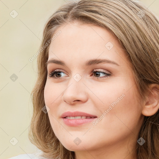 Joyful white young-adult female with long  brown hair and blue eyes