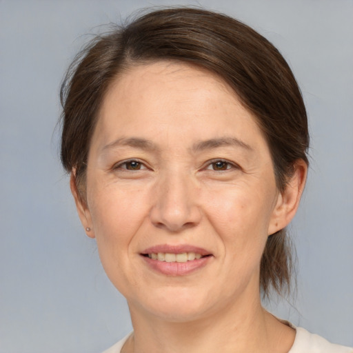 Joyful white adult female with medium  brown hair and brown eyes