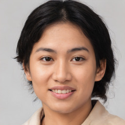 Joyful asian young-adult female with medium  brown hair and brown eyes