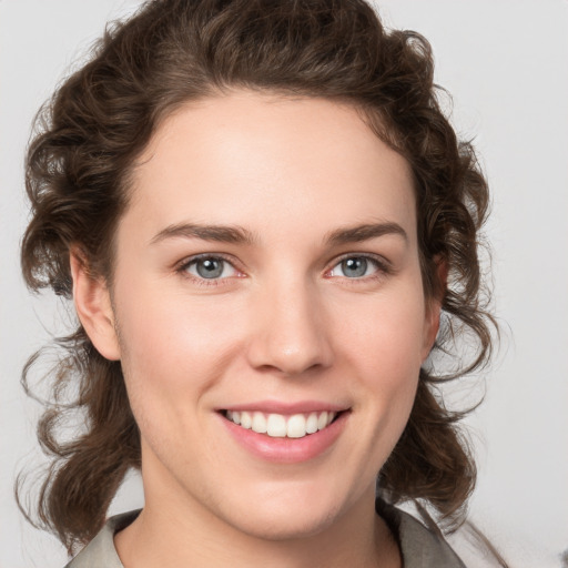 Joyful white young-adult female with medium  brown hair and green eyes