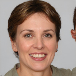 Joyful white adult female with medium  brown hair and brown eyes