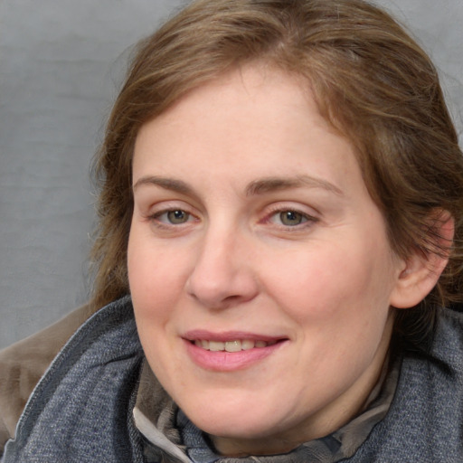 Joyful white young-adult female with medium  brown hair and blue eyes