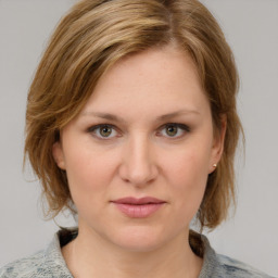 Joyful white young-adult female with medium  brown hair and blue eyes